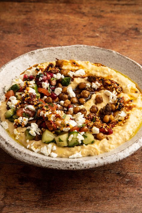 This is not your average hummus. With a kick of homemade chilli oil, the crunch of ras el hanout-fried chickpeas and a hearty hummus base infused with preserved lemon, this loaded recipe is packed with flavour and sure to impress. Pomegranate Recipes Salad, Sous Vide Vegetables, Lemon Hummus, Homemade Chilli, Pomegranate Recipes, Preserved Lemon, Chilli Oil, Pomegranate Salad, Great British Chefs