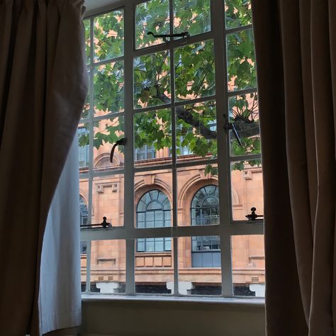 A view, with curtains on both sides, of the window that shows another building Hotel Room Window, Feels Aesthetic, London Hotel Room, Boutique Art, Aesthetic London, London Hotel, London View, Victorian London, Bow Window