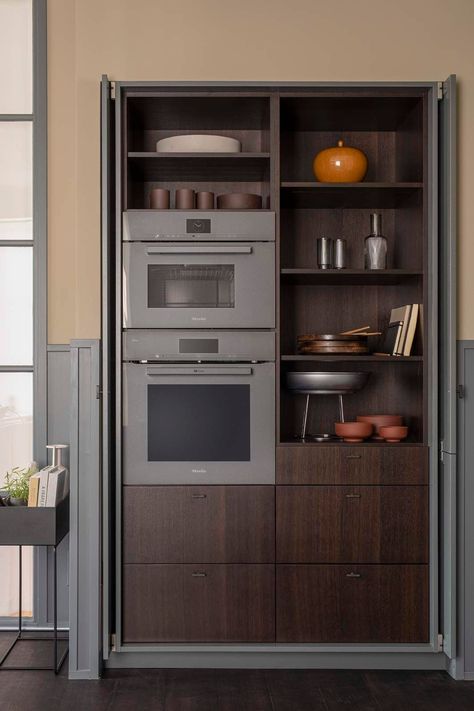 Austere grey/green cabinets with walnut interior. Appliances are closed away with pocket doors Oven Cabinet, Clever Kitchen Storage, Kitchen Storage Space, Kitchen Organisation, Dressing Rooms, Green Cabinets, Pantry Design, Pocket Doors, Wall Oven