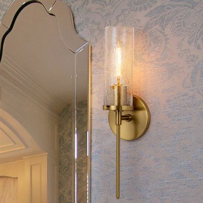 This modern glass wall sconce possesses a long shape accented with a stylish brass gold finish. With 19.7 inches in length, It is suitable for any large living room like a modern twist on a torch. This armed sconce helps to save and to brighten the space. Or install it in the bedside or rest area. With a cracked glass shade cover, that creates a warm ambiance, this gold wall lighting fits most the home style. And since it's designed to be compatible with damp spaces, this piece is also a great o Glass Sconces Bathroom, Speakeasy Sconces, Wall Sconces Living Room Next To Tv, Fireplace With Sconces And Tv, Gold Sconces Bedroom, Gold Bathroom Sconces, Bathroom Mirror With Sconces, Vanity Sconces Bathroom, Interesting Kitchens