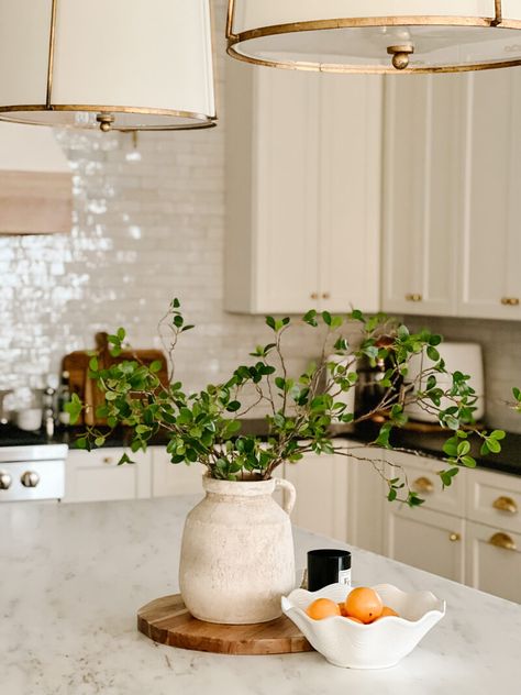 Decorations For Cabinet Tops, Kitchen Island Decor Simple, Herbs On Kitchen Island, Above Cabinet Decor Kitchen Greenery, Green French Country Kitchen, Styling An Island, Kitchen Island Staging, Centerpiece Kitchen Island, Island Decor Kitchen