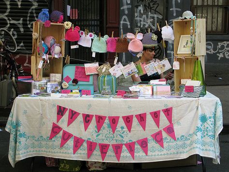 Build stacks of boxes on either side and hang a garland (of letters, info, business cards, bubbles or products) between for visual attraction Craft Table Display, Craft Stall Display, Craft Fair Table, Craft Show Booths, Craft Show Booth, Craft Booth Display, Vendor Displays, Window Crafts, Craft Fairs Booth