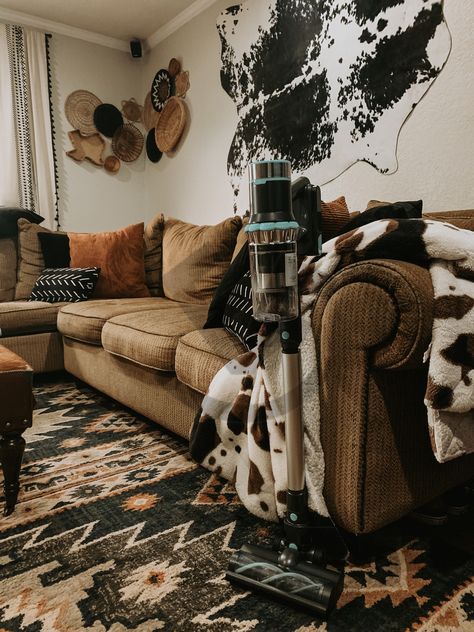 Cowprint Living Room Rug, Cowhide Rug Living Room Boho, Moody Cowboy Aesthetic, Cow Hide On The Wall, Cow Print Decor Living Room, Cow Theme Living Room Home Decor, Cow Print Rug Bedroom, Cowhide On Wall Ideas Living Room, Cow Hide Rug Bedroom Ideas