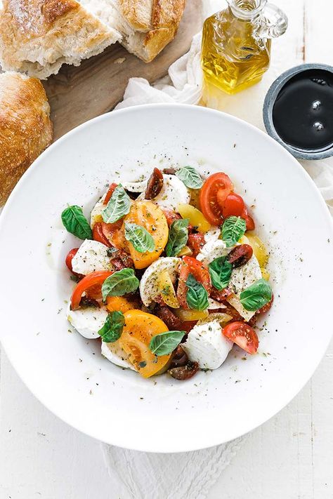 Take your salad game to the next level with this authentic Italian Caprese Salad. This is jam-packed with fresh ripe tomatoes, buffalo mozzarella, herbs, and extra virgin olive oil that boasts tons of flavor. You can also serve this up with pasta, chicken, cucumbers, avocado, or even peaches to customize it and make it your own. #salad Caprese #chicken Italian Caprese, Salad Caprese, Italian Caprese Salad, Baja Fish Tacos, Caprese Salad Recipe, Basil Olive Oil, Pasta Chicken, Tomato Season, Buffalo Mozzarella