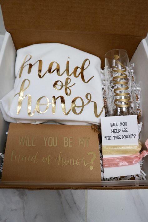 Treat your Bridesmaids and Maid of Honor to this Proposal box including all of the necessities! All lettering and designs are hand written. No fonts or stencils used.  WHAT YOU GET : (1) Crewneck T-Shirt with Bridesmaid or Maid of honor (choose color and size shirt, color of writing, and BM or MOH) (1) 9oz stemless champagne flute w/ name  (2) Random color hair-ties on card  (1) Proposal Card  (1) White box w name on top  HOW TO ORDER: Select color and size or t-shirt and color of writing. Pleas Bridal Shower Bachelorette Party Ideas, With Bridesmaid, Stemless Champagne Flutes, Maid Of Honor Proposal, Bridesmaid Box, Proposal Box, Bridesmaid Proposal Box, Bridesmaid Proposal Gifts, Future Wedding Plans