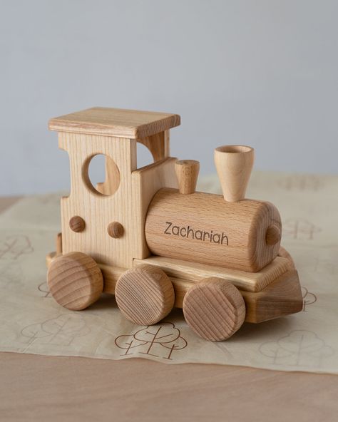 If you’re looking for a cute first train for little ones to get excited over then this is your piece! A perfect toy for toddlers to develop creativity, imagination, as well as fine and gross motor skills. Will also make a great piece for nursery or playroom decor. The train is beautifully handmade with cute high quality finishing touches and details. Includes three carriages carrying various wooden blocks, and a pull along string. Perfect for little hands to take along with them on their travels Train Nursery, Wood Train, Pull Along Toys, Wooden Building Blocks, Toy Wood, Wooden Building, Craft Booth Displays, Wooden Buildings, Nursery Decor Boy