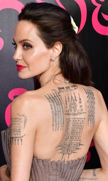 Iconic Tattoos, Angelina Jolie Tattoo, Tattoo Cover Up, Tattoo Cover, Tattoo Cover-up, Deep Meaning, Dark Skin Women, Charlize Theron, Big Tattoo