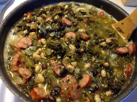 Swamp Soup! Ingredients: 2 large cans Old Glory seasoned turnip greens, 2 small cans black beans, 2 small cans navy beans, 2 cans chicken broth, 1/2 onion, minced garlic, 1 package Conecuh sausage.   Directions: chop onion, cut sausage into bite size pieces and brown on med heat.  Once browned add remaining ingredients and season to your liking.   Add a side of corn bread and enjoy! Black Eyed Pea Stew, Turnip Green Soup, Beans And Greens, Blackeyed Peas, Braised Kale, Sausage Stew, Black Eyed Pea, Salt Pork, Green Soup