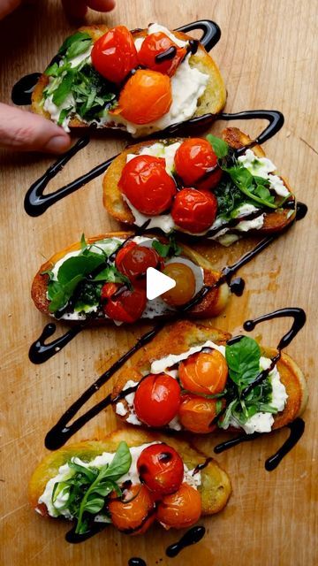 Dennis Prescott on Instagram: "Summer In A Bite = Confit Tomato, Basil Vinaigrette, & Burrata Crostinis. Perfect For Patio Celebrating. Full Recipe Below!

Confit Tomatoes

2 1/2 pounds mixed cherry tomatoes
1 head garlic, halved
3 fresh rosemary sprigs
1 1/2 cups olive oil
Sea salt and cracked black pepper

Basil Vinaigrette

4 cloves of your roasted garlic
2 cups tightly packed basil leaves
Juice of 1/2 lemon
1/2 tablespoon maple syrup
1 1/4 cups tomato-y olive oil
Sea salt and cracked black pepper

To Build

1 - 2 balls burrata
1/4 cup minced fresh basil
1 cup watercress
1 baguette, sliced and toasted
Juice of 1 lemon
Balsamic reduction, to serve

Preheat your Traeger Grill to 250 degrees F. In a pan, combine the tomatoes, garlic, rosemary, olive oil, season with salt and pepper, then r Confit Tomatoes, Dennis Prescott, Fresh Basil Recipes, Confit Recipes, Rosemary Olive Oil, Toasted Crostini, Basil Vinaigrette, Garden Cooking, Balsamic Reduction