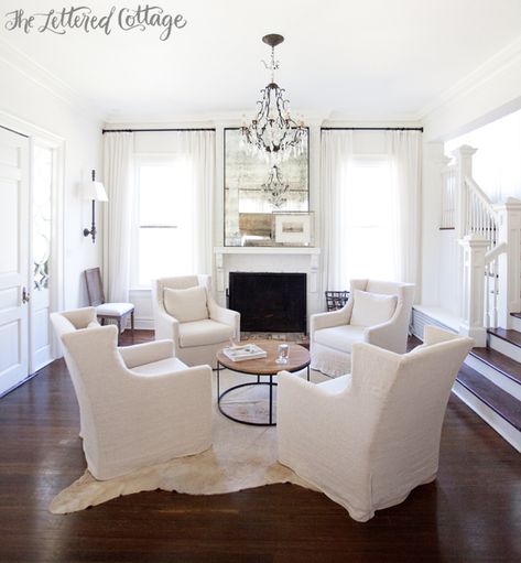 Neutral Living Room | White | Slipcovers | Cowhide Rug | Wall Sconces | Fireplace | Round Coffee Table | Ashley Gilbreath Interiors Ashley Gilbreath Interiors, Living Room Arrangements, Hearth Room, Cottage Living Rooms, Neutral Living Room, Living Room White, Living Room Remodel, Family Room Design, Cottage Living