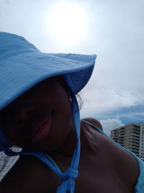 Black girl at the beach sitting on the sand in a blue bikini and blue hat. Morning At The Beach, Aesthetic Ethereal, Aesthetic Sun, Girl Lifestyle, Hat Summer, Aesthetic Black, Beach Aesthetic, Beach Girl, Travel Aesthetic