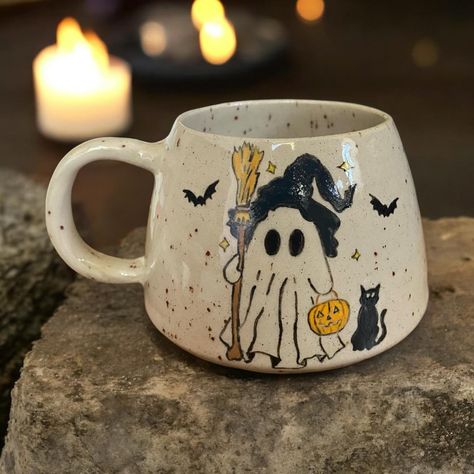 ✨ 🕯️ Witchy Ghost 🕯️ ✨ #pottery #handmade #handmadepottery #londonpotters #ceramics #ceramicart #autumn #autumnvibes #stoneware #wheelthrown #coffee #coffeetime #coffeelover #coffeeshop #mug #coffeemug #tableware #halloween #handmadeceramics #functionalpottery #londonartist #handmadepottery #mugs #functionalceramics #handthrown #handcrafted #handmademug #pottersofinstagram #wheelthrowing Painted Pottery Halloween, Halloween Mug Painting Ideas, Paint A Pot Ideas Mug, Halloween Ceramics Pottery, Pottery Painting Autumn, Halloween Mug Ideas, Fall Mug Painting Ideas, Halloween Pottery Painting Ideas, Pottery Painting Halloween