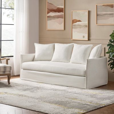 This transitional sofa comes with a handy slipcover that lets you match with almost any aesthetic. It has an engineered wood frame that rests on metal legs, while a solid-toned polyester fabric wraps around the entire piece, successfully merging traditional and modern. The cushions are filled with cotton over pockets and sinuous springs to provide ample support as you stretch out and relax after a long day. Classic pillow backs lend even more padding to your hangout space. Take note: A minimum d One Cushion Sofa, Living Room Couch And Chairs, Two Couch Living Room, Preppy Couch, Couch In Bedroom Ideas, Wayfair Sofa, Affordable Couches, Linen Loveseat, Modern White Sofa