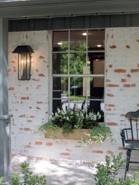 Prior to the renovation, the home exterior was plain brown brick. The distinctive whitewashing effect was achieved through a technique known as German mortar smear. German Smear Brick, German Smear, Hgtv Fixer Upper, 70s House, Magnolia Farms, Brown Brick, Magnolia Market, Chip And Joanna Gaines, Painted Brick