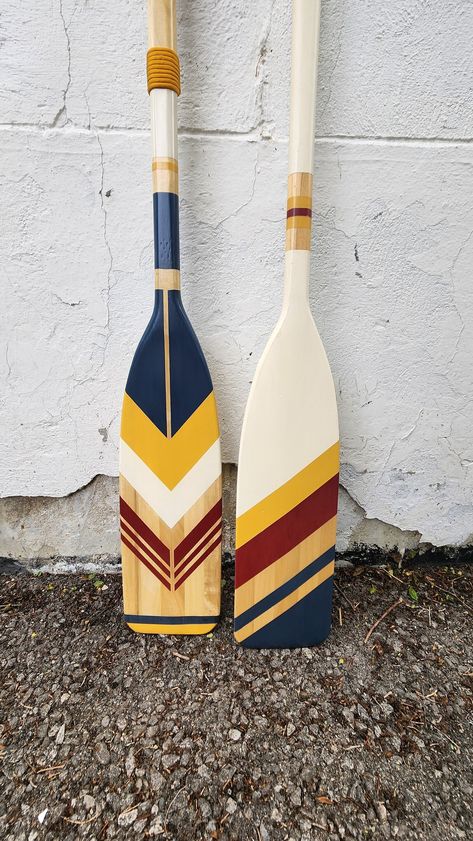 Series name: "Explorer" Hand painted wooden canoe paddle. Colour: light stained with white, red, yellow and blue strips. These paddles are for decorative purposes, not for in-water use. If you would like to have a custom paddle made please contact me directly to discuss the design and costs.  *Note: Most paddles are made to order and can be shipped within 7-10 days Painted Oars Paddles, Canoe Paddle Art, Painted Oars, Oar Decor, Painted Paddles, Wooden Canoe, Lake House Interior, Canoe Paddle, Wall Art Coastal