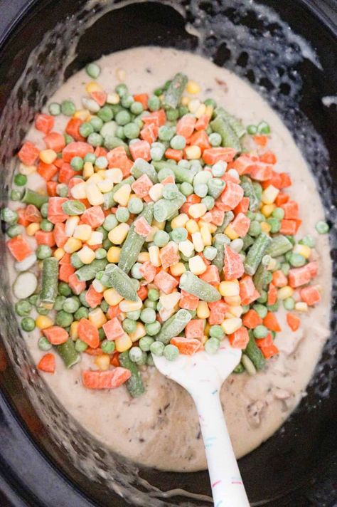 frozen mixed veggies on top of a creamy chicken mixture in a crock pot Frozen Mixed Vegetable Recipes, Vegetable Crockpot Recipes, Frozen Chicken Crockpot, Frozen Vegetable Recipes, Easy Slow Cooker Dinner, Crockpot Veggies, Mix Vegetable Recipe, Slow Cooker Chicken Pot Pie, Vegetable Slow Cooker