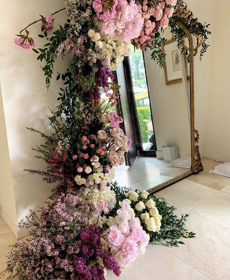 Cascading floral around mirror Valentine’s Day Floral Installation, Flower Wall Around Mirror, Flowers And Mirror Centerpiece, Flower Wall Mirror, Wedding Mirror With Flowers, Flower Wall With Mirror, Mirror Backdrop Ideas, Backdrop With Mirror, Cascading Floral Arrangements