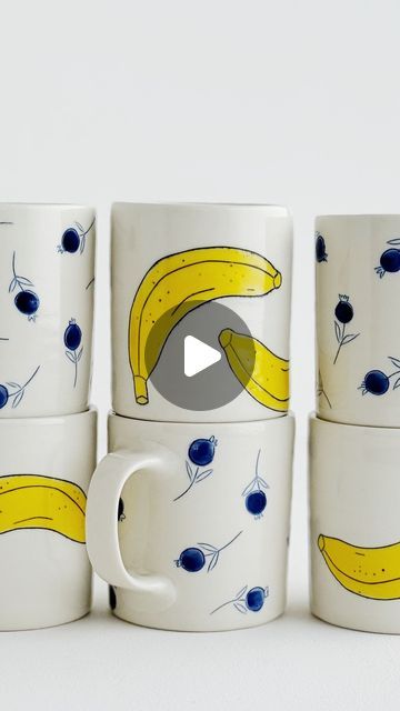 Jenna Vanden Brink Ceramics on Instagram: "Decorate a banana mug with me!

I inlay these at the bone dry stage with no wax resist.

After the mugs are bisque fired, I paint a watered down underglaze on top of the carved+inlaid drawing.

Finally, they get dunked in a clear glaze and glaze-fired to cone 8 in my electric kiln.

🍌🍌🍌" Wax Resist, A Banana, The Bone, Kiln, Glaze, Wax, Carving, Paint, Ceramics