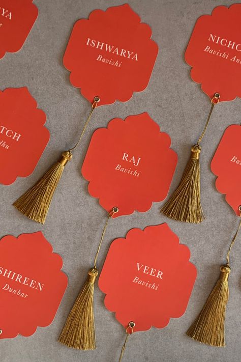 Indian inspired wedding place cards Cute Place Cards Wedding, Tassel Name Card, Tassel Place Cards, Party Name Tags Ideas, Indian Wedding Details, Multi Cultural Wedding, Wedding Collaterals, Indian Wedding Stationery, Indian Inspired Wedding