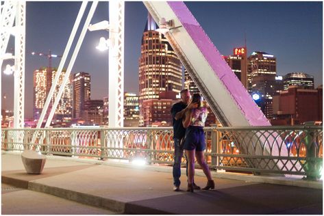 A Nashville Pedestrian Bridge Proposal of a couple from Florida on a trip with friends. A very sweet proposal on the beautiful bridge in Nashville TN. Nashville Proposal, Bridge Proposal, Nashville Skyline, Trip With Friends, Steel Trusses, Pedestrian Bridge, New Netflix, Over The River, Engagement Portraits