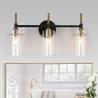 Bring a boost of brightness to your bathroom, hallway, entryway, and more rooms with this modern 3-light vanity light. Vintage yet bright shiny brass finish with matte black brings modern chicness and also blends in the farmhouse and traditional house styles. 3 premium transparent glass shades will emit bright lighting over your vanity mirrors. You can use a standard dimmer switch and dimmable bulbs (both not included) to adjust the brightness according to your preference. Finish: Black/Brass | Bathroom Lighting Over Mirror Modern, Magnolia Bathroom, Washington House, Black And Gold Bathroom, Modern Vanity Lighting, Vanity Lights Bathroom, Lamp Ideas, Restroom Decor, Ensuite Bathrooms