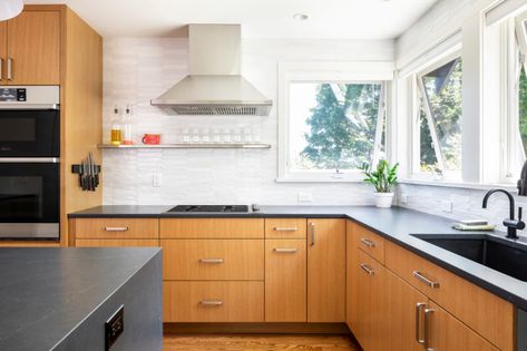 Wood cabinets, white counter-to-ceiling backsplash tile from Tierrra Sol and black soapstone countertops | Mid-Century Modern Kitchen with Yellow & Green | Model Remodel, Seattle, WA © Cindy Apple Photography Mid Century Modern Kitchen Remodel, Mid Century Modern Kitchen Design, Soapstone Kitchen, Modern Black Kitchen, Modern Kitchen Remodel, Dark Countertops, Maple Kitchen, Black Countertops, Mid Century Modern Kitchen