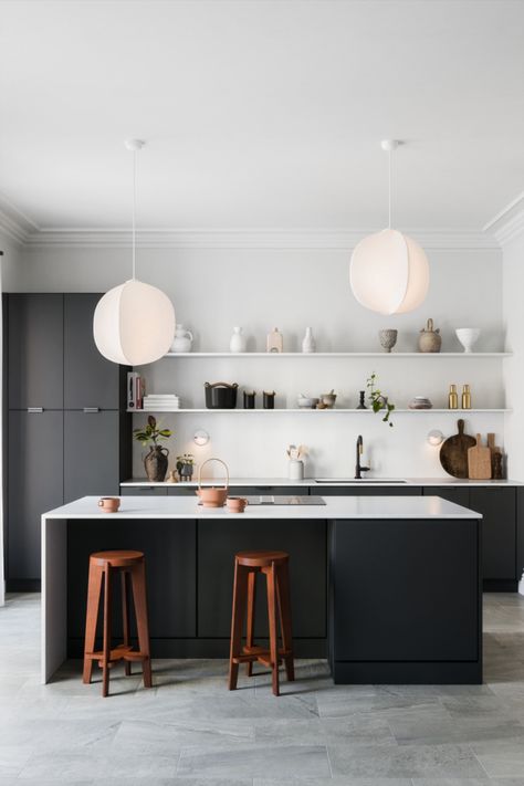 This kitchen is inspired by contemporary Japanese design. Natural materials like wood and clay accent an otherwise restrained palette. When looking for ideas on how to renovate your kitchen, it's easy to get overwhelmed. So take a page from minimalism and set some parameters and contstraints for your project— pradoxically, you may find yourself being more creative in the process. Small Black Kitchen, Black And Cream Kitchen, Kitchens 2024, 2025 Kitchen, Kitchen Japandi, Wood Cottage, Modern Minimalist Kitchen, 2024 Kitchen, Nordic Kitchen