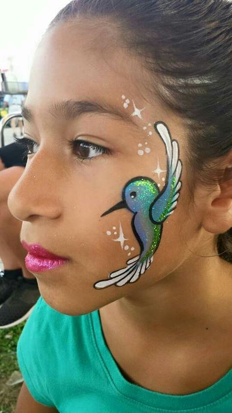 Hummingbird Face Painting. Rainbow Face Paint, Animal Face Paintings, Bodysuit Tattoos, Festival Face Paint, Face Painting Tips, Cheek Art, Girl Face Painting, Face Painting Tutorials, Rainbow Face