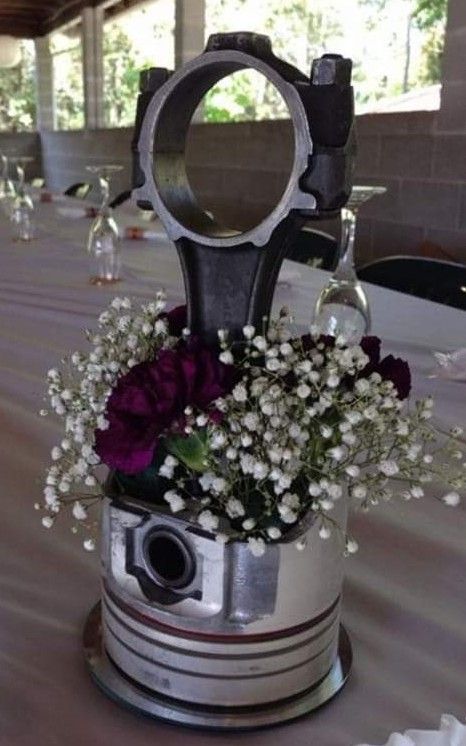 Piston centerpieces Piston Centerpiece Wedding Ideas, Mechanic Decorations Party, Race Theme Wedding Ideas, Piston Welding Art, Dirt Bike Centerpiece Ideas, Car Themed Wedding Centerpieces, Motorcycle Wedding Decorations, Drag Racing Wedding Ideas, Tool Centerpiece Ideas