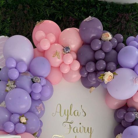 Balloon & Event Stylists 🤍Surrey on Instagram: "Fairy 🧚 themed 1st Birthday party set up, using our sailboard, with personalisation in brushed gold, surrounded by a beautiful garland using our faves @kalisan Lavender, lilac, & macaron pink with butterflies & flowers to finish this design off, our plinth was perfect for this beautiful cake by @lolas_cupcakes And you couldn’t have a first birthday without a LED number 1 Thanks to @funtimeprops . . . . . . . . . . . . . . . . . . . . . . . . . . Lilac Butterfly Birthday Party Ideas, Purple Butterfly Balloon Garland, Purple And Gold Butterfly Birthday, Purple Butterfly First Birthday, Pink And Purple Butterfly Balloon Arch, Themed 1st Birthday, Birthday Party Set, Butterflies Flowers, Girl Birthday Themes