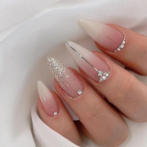 Return Policy Fast Delivery Trusted seller Silver Glitter Press on Nails French Tip Fake Nails Medium Almond False Nails with Rhinestone Design Nude Glue on Nails Glossy Artificial Acrylic Full Cover Diamond Stick on Nails for Women Manicure Product Description Package About:Silver glitter french tip false nails.The package contains 24 Pcs of medium almond press on nails of different sizes,1 adhesive tabs,1 small wooden stick,and 30 pieces nail glue stickers.You can safely choose a fake nail that fits your finger size Material:The rhinestone glue on nails are made of ABS materials.The glossy full cover stick on nails reusable with moderate thickness are not easy to break,use the nail glue sticker we gave you,stick on nails is brings you a comfortable experience Easy to Apply:Glitter stick Bouquet Nails, Red Nails Art, Almond French Tips, New Years Eve Nail, Trendy Nude Nails, Viral Nails, Pink Stiletto Nails, Statement Nails, Bridal Nail