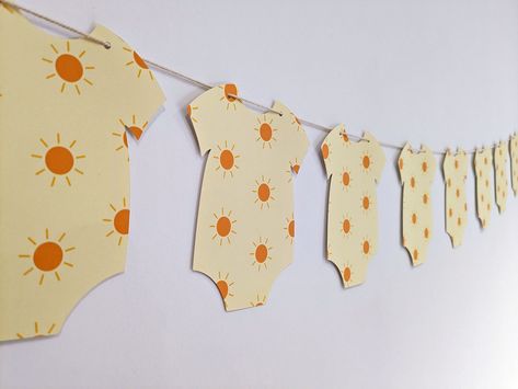 Baby Onesie Garland, You Are My Sunshine Gender Reveal, Her Comes The Son Baby Shower Ideas, A Little Ray Of Sunshine Is On The Way, Sunshine Gender Reveal, Baby Shower Sunshine Theme, Sun Baby Shower Ideas, Little Ray Of Sunshine Baby Shower Ideas, Sunshine Theme Baby Shower Ideas