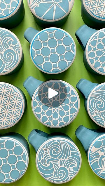 Renee LoPresti on Instagram: "🟢Colored slip [mug bottom] patterns 🟢 . I know I’ve been a bit quiet for the past couple of weeks; I have been busy throwing and prepping mugs, planters and tumblers for the decorating phase!  . Here I am using custom reusable die cut vinyl on leatherhard porcelain coffee mug bottoms. I like using a washable marker to mark where I want the slip to stop (and to ensure a perfectly centered circle). The vinyl is compressed onto the surface, and colored porcelain slip applied over the stencil.  . Each design corresponds with how the sides of the mug will be decorated (coming up next!). This slip will become a more vibrant blue-green color when fired. Happy Friday everyone!" Colored Slip Pottery, Slip Trailing Pottery Patterns, Stencil Ceramics, Pottery Patterns, Washable Markers, Happy Friday Everyone, Cricut Creations, Pottery Designs, Vibrant Blue