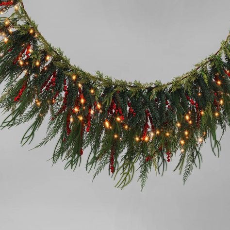 Add sparkle to the holiday season with this Pre-Lit Mixed Greenery and Red Berries Artificial Christmas Garland Green with Warm White Lights from Wondershop™. This ready-to-hang Christmas garland detailed with natural-looking pine branches and red berries makes a wonderful addition to your seasonal decorations. It comes pre-lit with warm white bulbs to add a bright, festive glow to your space. The artificial construction allows for use year after year in a variety of spaces. Welcome to the Wonde Window Garland, Wall Garland, Indoor Holiday Decor, Warm White Lights, Neutral Christmas Decor, Target Holiday, Artificial Christmas Garland, Dark Christmas, Artificial Garland