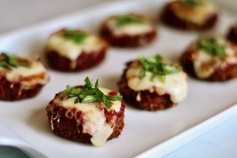 Petite discs of tender eggplant are delicately coated in a crisp breadcrumb crust, crowned with a dollop of rich marinara sauce and gooey mozzarella cheese. These mini eggplant parm appetizers are bite-sized wonders that encapsulate the essence of traditional eggplant parmesan in a single bite. Mini Eggplant, Eggplant Parm, Bite Size Appetizers, Roast Eggplant, Eggplant Parmesan, Baked Brie, Chicken Cutlets, Baking Set, Shredded Mozzarella