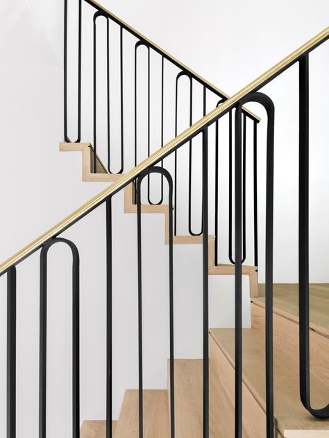 The staircase handrail was custom designed by Unicus Developments specifically for this renovation. It’s constructed from a combination of iron and unlacquered brass. The craftsman applied a step notch—a linear cutout—to each stair tread. Custom Metal Railing, Brass Stair Railing, Brass Railing, Vertical Iron Stair Railing, Brass Handrail Stairs, Brass Handrail, Brass Balustrade, Stairs Relling Design Iron, Steel Spine Staircase