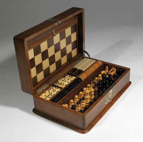 VICTORIAN OAK CASED GAME SET. The hinged oak box adorned with ornate applications, opening to reveal a fitted portable carrying tray holding 32 wood chess pieces in ebony & fruitwood; 34 checkers, also in ebony and fruitwood; set of dominos; and 2 sets of playing cards. The inner lid holds a removable chess board. Box measures 13.25 inches W., 8.25 inches D., by 4.50 inches Portable Chess Set, Victorian Games, Chess Board Set, Chess Board Game, Wooden Board Games, Chess Table, Wood Games, Vintage Board Games, Wood Chess