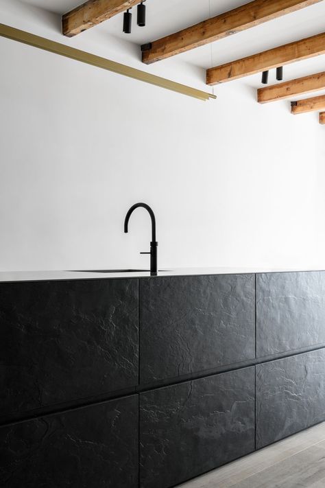 Clean kitchen island made of black slate veneer with minimal lines and a black sink. Slate Kitchen Island, Black Slate Kitchen, Custom Made Kitchen, Slate Veneer, Slate Kitchen, Lines Design, Modern Kitchen Island, Line Design, Modern Kitchen