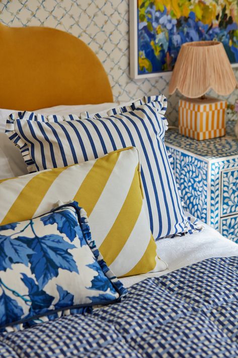 Scatter cushions on bed in bright blues, yellows and white. Sophie Robinson, Classic Paper, Lapis And Peridot, Maximalist Interior, Creative Interior Design, Home Grown Vegetables, Painted Rug, Stripe Fabric, Fabric Accessories