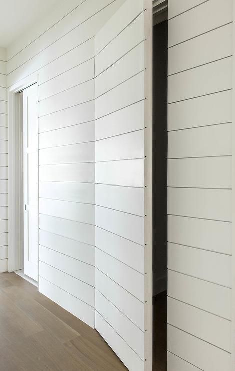 White shiplap hallway walls help to conceal a powder room behind a white shiplap jib door. Shiplap Hallway, Jib Door, Secret Door Ideas, Dold Dörr, Hidden Doors In Walls, Hallway Walls, Invisible Doors, White Shiplap Wall, Door Diy