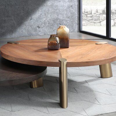 This Grider 3 Legs Coffee Table provides the perfect tabletop solution for all needs. The circular-shaped table tops are MDF with a walnut veneer or dark wenge veneer topped with lacquered for maximum duration. This coffee table features 3 brushed stainless steel legs in brass. Table Top Color: Walnut, Size: 17" H x 63" L x 63" W | Brayden Studio® Grider 3 Legs Coffee TableWood/Metal in Brown, Size 17.0 H x 63.0 W x 63.0 D in | Wayfair Art Deco Coffee Table Vintage, Large Round Coffee Table, Coffee Table Luxury, Coffee Table Walnut, Table Wood Metal, Art Deco Coffee Table, Stump Table, Metal Furniture Design, Brass Coffee Table