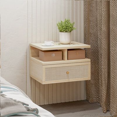 This floating end table mounts to the wall, saving you floor space in your bedroom with a sleek, modern style. It's crafted from manufactured wood in a smooth, natural finish. The wall-mounted design features a rectangular shape, and that includes both an open shelf and a drawer. Their floating construction means there's space underneath for slippers or a storage basket. | Bayou Breeze Bellarose Block End Table w / Storage Wood in Brown | 10.67 H x 15.75 W x 12.13 D in | Wayfair Rattan Bedroom, Narrow Nightstand, Floating Bedside Table, Drawer Lights, Wall Hanging Designs, Oak Wall, Bedside Night Stands, Mesa Exterior, End Tables With Storage