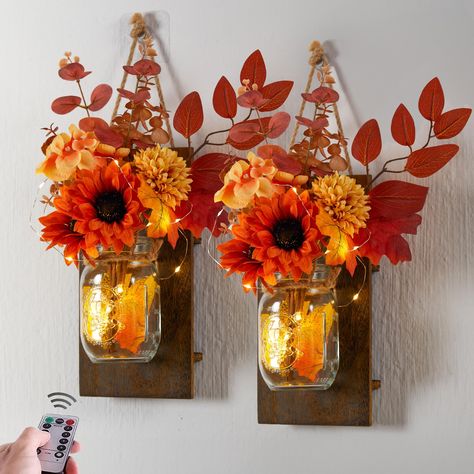 PRICES MAY VARY. 【2 Pack Decorative Jar】One package includes 2 mason jars, 2 rustic wood holders, and LED string lights(batteries not included), and 2 artificial flowers bouquets. The size of wooden board is 10.45*5.19in, the length of LED string is 78.74in. 【Unique Floral Matching】Each bouquet contains six different elements, including a pumpkin,4 chrysanthemums, 2 pine cones, some maple leaves, and other accessories. 【Multiple Lighting Effects】The LED lights feature 6-hour timing and remote co Farmhouse Wall Art Diy, Fashion Decor Bedroom, Mason Jar Sconces, Fall Decorations For Home, Fall Living Room Decor, Wall Decor Rustic, Rustic Wall Sconces, Fall Wall Decor, Rustic Fall Decor