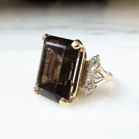 This is a beautiful vintage Smoky Topaz & diamond gemstone cocktail ring. The huge topaz measures 15mm x 19.9mm. It has little scratches all over it & one small chip in one side facet. There are 10 marquise diamonds that accent the topaz setting. They measure 2.2mm x 3.7mm each. The total carat weight in diamonds is .70ct. They have I color with SI1-I1 clarity. Totla weight of the ring is 14.grams/9dwt. This is a vintage, previously owned ring. Therefore, light wear can be expected. This Smokey Topaz Ring, Sky Blue Topaz Ring, Queens Jewels, Vintage Cocktail Ring, Smoky Topaz, Black Diamond Ring, Wedding Vibes, Vintage Cocktail, Blue Topaz Ring