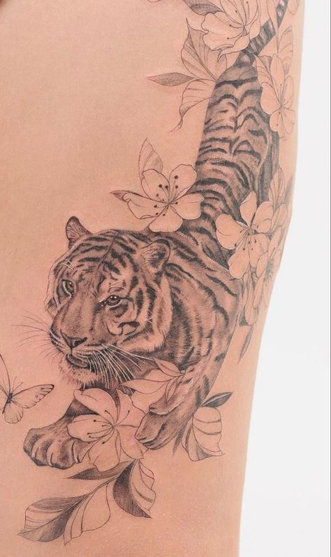 Tiger Tats For Women, Tiger With Hibiscus Tattoo, Tiger Tattoo Side Ribs, Japanese Tiger Cherry Blossom Tattoo, Bengal Tiger Tattoo For Women, Tiger And Leopard Tattoo, Lower Back Tiger Tattoo, Cheetah Tattoos For Women, Large Tiger Tattoo