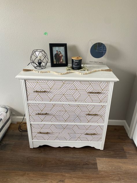 I took an old white dresser and turned it into this with only a few simple steps. 1. Simple white paint over top and sides. 2. Wallpaper over dresser drawers #wallpaper #dresser #diy #makeover Peel And Stick Wallpaper Dresser, Drawers Wallpaper, Dresser Diy Makeover, Diy Upcycled Decor, Wallpaper Dresser, Gold Geometric Wallpaper, Dresser Diy, Nice Wallpaper, Hexagon Wallpaper