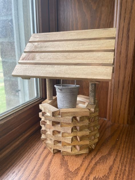 Wishing well made from dollar tree pallets, jenga blocks, tiny red solo cup, twine, handles of foam brushes, and fix all adhesive. I also took the metal from one of those wedding buckets (which was too big for my well) and stuck it through the red solo cup. Waverly chalk paint from Walmart. Antique wax from Home Depot. Jinga Crafts, Diy Wishing Well, Jenga Crafts, Diy Wishing Wells, Wedding Bucket, Waverly Chalk Paint, Jenga Blocks, Red Solo Cup, Tumbling Blocks