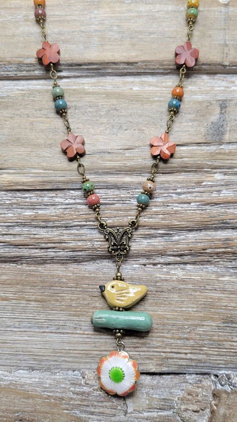 "Yellow bird sitting on a light turquoise branch with dangling cloisonne flower. Accented with dark orange wood beads & multicolored porcelain beads. Finished off with brass chain this necklace measures 20\" in length. It closes with a lobster clasp & has a 2\" extender." Diy Necklace Designs, Czech Beads Jewelry, Plate Jewelry, Artsy Jewelry, Vintage Assemblage Jewelry, Gel Plate, Boho Necklaces, Bird Sitting, Beaded Things