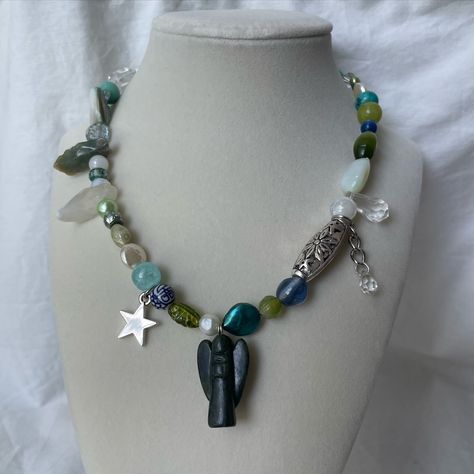 jade angel - available now! ₊˚ʚ 🌱 ₊˚✧ ﾟ. fulloffishes.square.site 🍵 handmade blue+green beaded necklace with a stone jade angel pendant, star charm, freshwater pearls, czech stones, glass beads, and crystals. adjustable 17-20in long #handmadejewelry #handmadebeadedjewelry #beadednecklace #freshwaterpearljewelry #orlandojewelry #orlandohandmade Green Beaded Necklace, Freshwater Pearl Jewelry, Angel Pendant, Handmade Beaded Jewelry, Upcycled Jewelry, Star Charms, Fresh Water, Freshwater Pearls, Jade