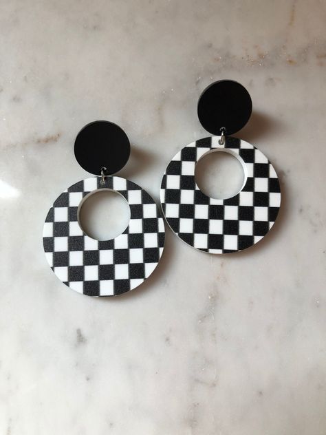 These are perfect racing earrings for your night at the track! Black and white checkered hoop acrylic pendant with a matte black acrylic stud. The checkered acrylic pieces are cut continuously, so the exact pattern may vary from the photo. Silver earring backs. Checkered Earrings, Black Acrylic Earrings, Beloved Jewelry, 60s Earrings, Track Black, Flag Earrings, Acrylic Pendant, Diy Earrings Polymer Clay, Black And White Earrings